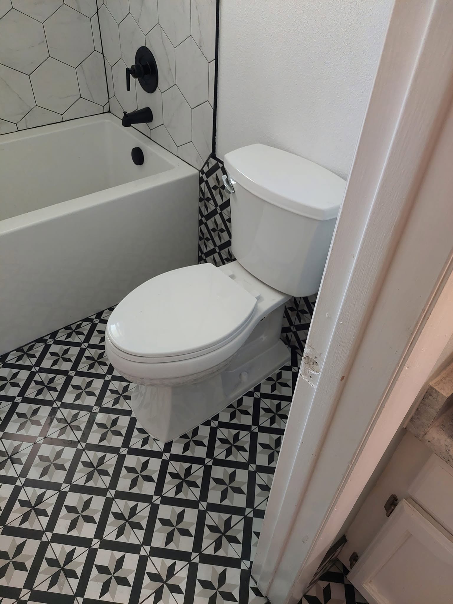 Completed bathroom plumbing project with tub and toilet